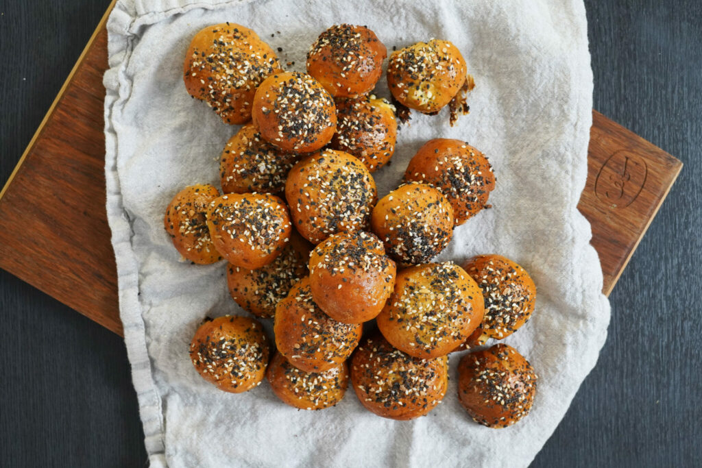 Balls of bagel dough stuffed with cream cheese and glazed with TikTok